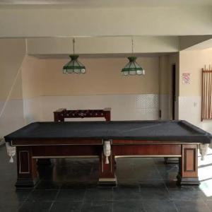 a pool table in a room with two lights at Refúgio Laguna in Araruama