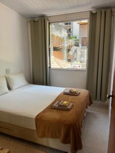 Ένα ή περισσότερα κρεβάτια σε δωμάτιο στο Vila quartos LemeCopa