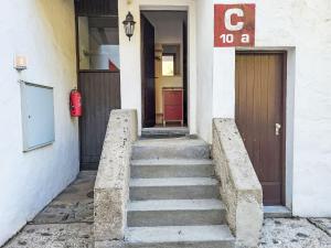 a set of stairs leading to a building with a door at Apartment Villaggio Sureggio C10A mit TicinoTicket by Interhome in Lugaggia