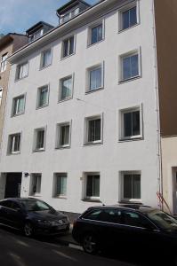 two cars parked in front of a white building at Wohnung in toller City-Lage 45 m2 in Vienna +20 photos