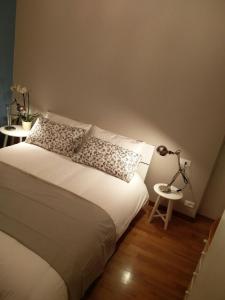 a bedroom with a bed and a lamp on a stool at Carlo's B149C - Sanremo Center Suite - da Carlo - in Sanremo