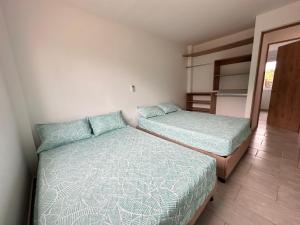 Postel nebo postele na pokoji v ubytování Cabaña 5 Playa Piso 1- Palmar De Los Vientos-San Bernardo del Viento