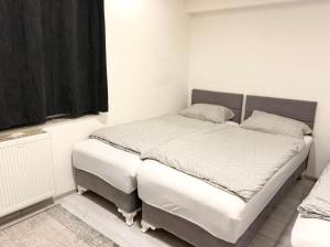 a bedroom with a twin bed in a room at Apartment Azra in Hrasnica