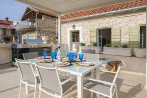 a white table and chairs on a patio at The Stone House in Zaton