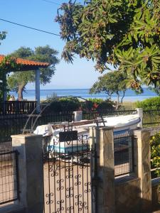 a gate with a swimming pool behind it at Katerina Beach House in Vergia