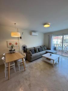ein Wohnzimmer mit einer Couch und einem Tisch in der Unterkunft Sunset Rooftop Terrace apartment in Palm-mar