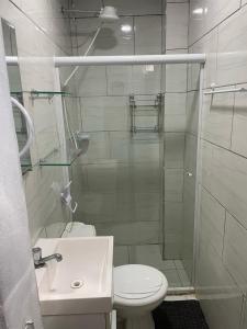 a bathroom with a toilet and a sink and a shower at Apartamento Chuá Chuá in Valença +9 photos