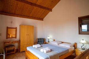 a bedroom with a large bed with two white pillows at Villa Amalia in Palekastron +51 photos