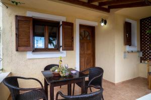 a table and chairs in front of a house at Villa Amalia in Palekastron +29 photos