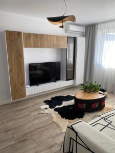 a living room with a large fireplace and a table at Apartament de lux in Tecuci