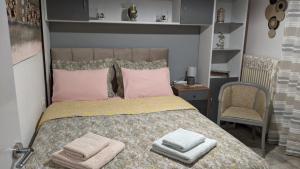 a bedroom with a bed with two towels on it at Cute apartment in Veria