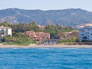 a view of a beach with buildings and the ocean at Marbella Beach Resort at Club Playa Real in Marbella