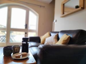 a living room with a leather couch and a coffee table at Romantic Escape and Stargazer's Hideaway nr Dark Sky, Alnwick, Kielder in Alnham
