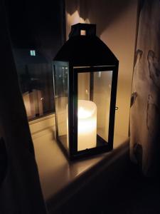 a candle in a glass lantern in a window at Romantic Escape and Stargazer's Hideaway nr Dark Sky, Alnwick, Kielder in Alnham +37 photos