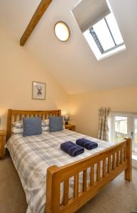 a bedroom with a bed with blue pillows on it at Romantic Escape and Stargazer's Hideaway nr Dark Sky, Alnwick, Kielder in Alnham