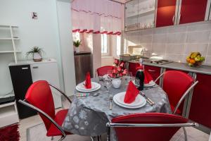 a kitchen with a table with santa hats on it at Apartman Đurđica in Lovran