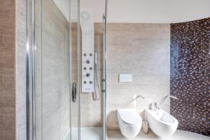 a bathroom with a shower and a sink and a toilet at Appartamento Rubino in Tricase +11 photos