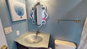 a bathroom with a sink and a toilet at Host on the Coast in Folly Beach +22 photos