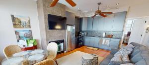 a kitchen and living room with a couch and a table at Host on the Coast in Folly Beach