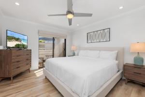 a white bedroom with a large bed and a window at Trackside Tranquility - TC522B in Solana Beach +25 photos