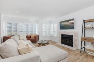 a living room with a couch and a fireplace at Trackside Tranquility - TC522B in Solana Beach