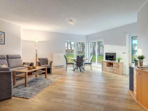a living room with a couch and a table at Haus Berlin, Wohnung 2 in Loddin