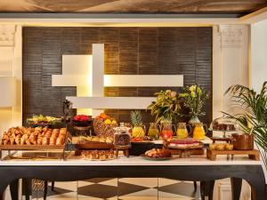 a buffet with many different types of food on a table at Sofitel Paris Le Faubourg in Paris +106 photos