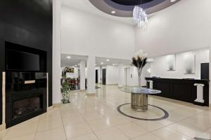 a lobby with a table and a fireplace at Sonesta Essential Savannah in Savannah