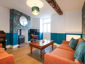 a living room with a couch and a coffee table at River Cottage in Derby