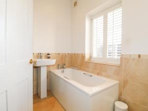 a bathroom with a tub and a sink and a window at River Cottage in Derby +35 photos