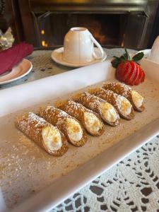 a tray of pastries with a strawberry on a counter at Angel of the Sea Bed and Breakfast in Cape May