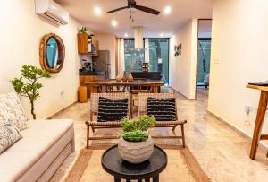 a living room with a couch and chairs and a table at Premium Apartment in Tulum 2 Bedrooms Roof Top Pool - Aldea Zama in Tulum
