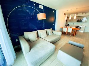 a living room with a couch and a table at Live Miami apartment with beach and near the mall in Abbeyville