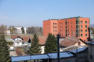 a large red brick building in a city at Apartman Mint&White Borik in Banja Luka