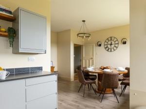 a kitchen and dining room with a table and chairs at The Poplars in Catwick
