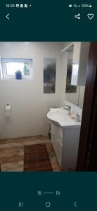 a bathroom with a sink and a mirror at Dom letniskowy nad jeziorem Wigry Staw Suwalszczyzna in Suwałki