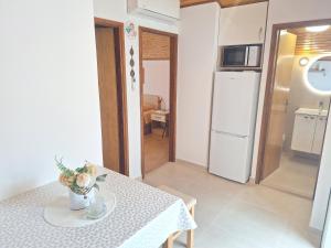 a small kitchen with a table and a refrigerator at Apartments Boris in Zaton +41 photos