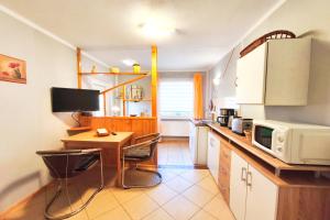 a kitchen with a desk and a microwave at Ferienwohnung Franke 1 3 in Zinnowitz