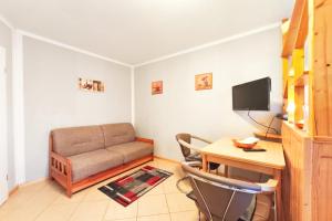 a living room with a couch and a desk at Ferienwohnung Franke 1 3 in Zinnowitz