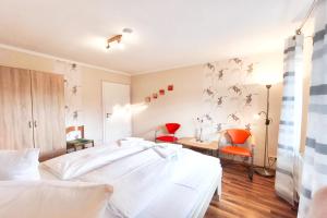 a bedroom with two beds and a desk and chairs at Ferienwohnung Franke 1 3 in Zinnowitz