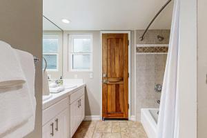 a bathroom with a sink and a wooden door at Hawaiian Style on Beach Rd in Dana Point +14 photos