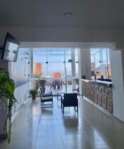 a lobby with chairs and tables in a building at Mochican Palace Hotel in Huanchaco