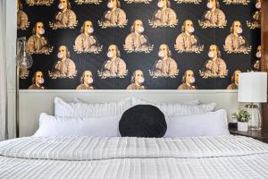 a bedroom with a bed with a black and white wallpaper at Modern Retreat Games BBQ Grill Close to Downtown in Omaha