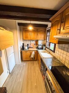 a kitchen with wooden cabinets and a counter top at Le ValBruche - Spacieux & Cosy - Centre Ville - Commerces à Proximité in Bischheim +22 photos
