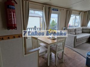 a living room with a table and a couch at 7 Lakes Breaks at 7 Lakes Country Park-WF73 in Crowle +40 photos