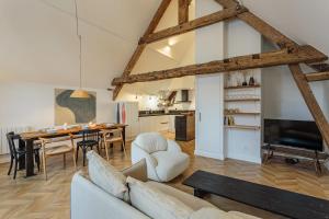 a living room with a couch and a table at Appartement Mer et Pierres - Welkeys in Saint-Jean-de-Luz