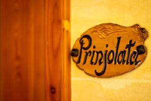 a sign on a wall with the word principal at Il figolla farmhouse in Xagħra