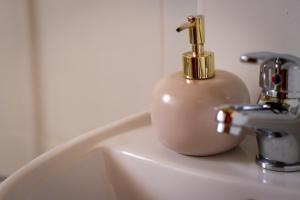 a soap dispenser sitting on top of a sink at Il figolla farmhouse in Xagħra
