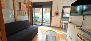 a living room with a couch and a table at Sabaris, Baiona, apartamento con terraza in Baiona