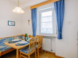 a dining room with a table and chairs and a window at Apartment Rosengartenhof-1 by Interhome in Andrian +36 photos